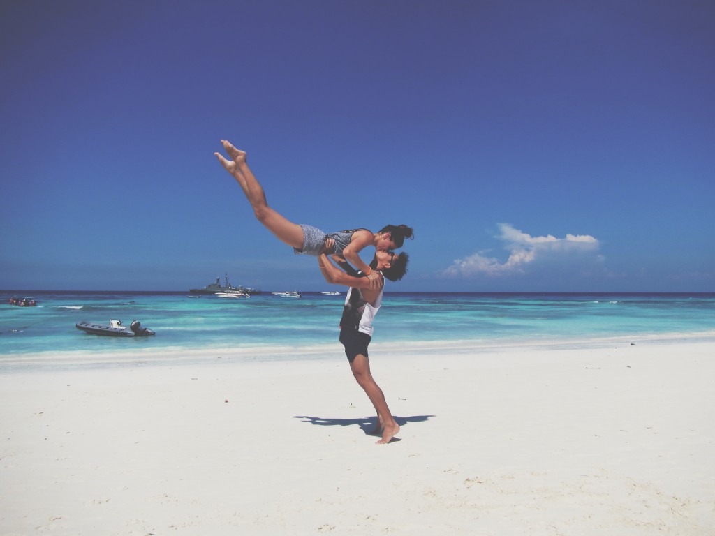 couple jumping on tachai island thailand