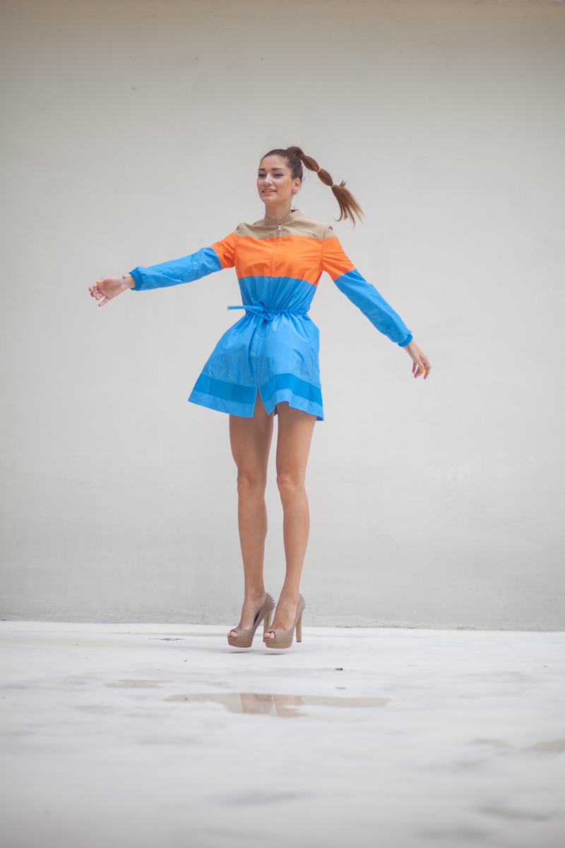 girl jumping wearing a colourblock dress
