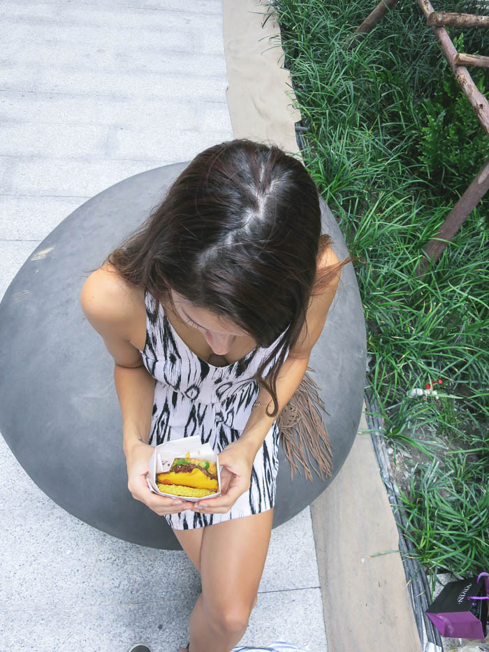 girl eating a ramen burger in Bangkok 