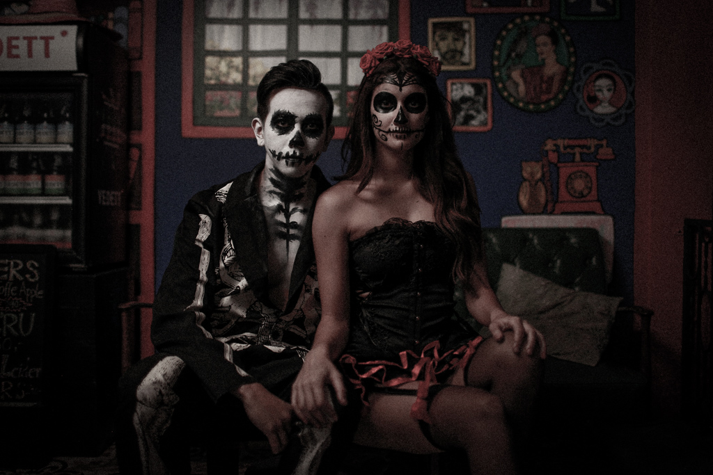couple wearing day of the dead make up and costumes