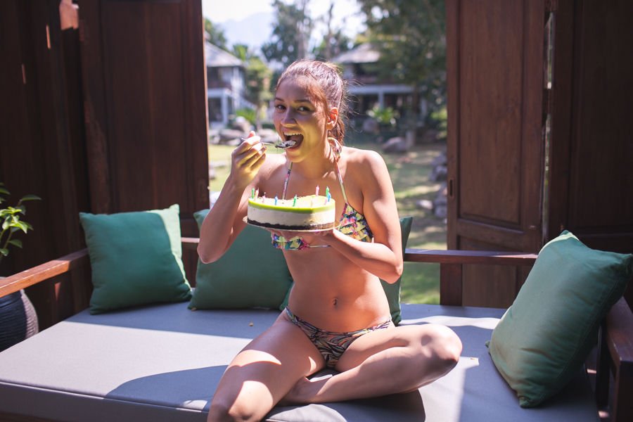 a girl sitting and eating cake