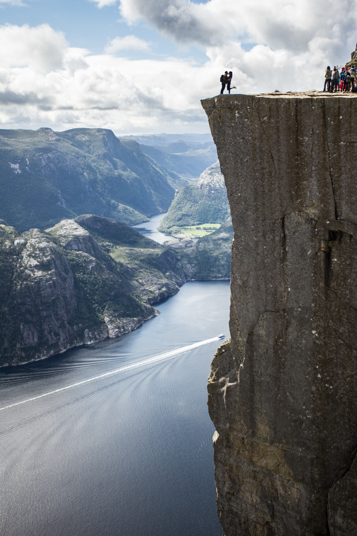 couple travelling norway kissing on pulpit rock
