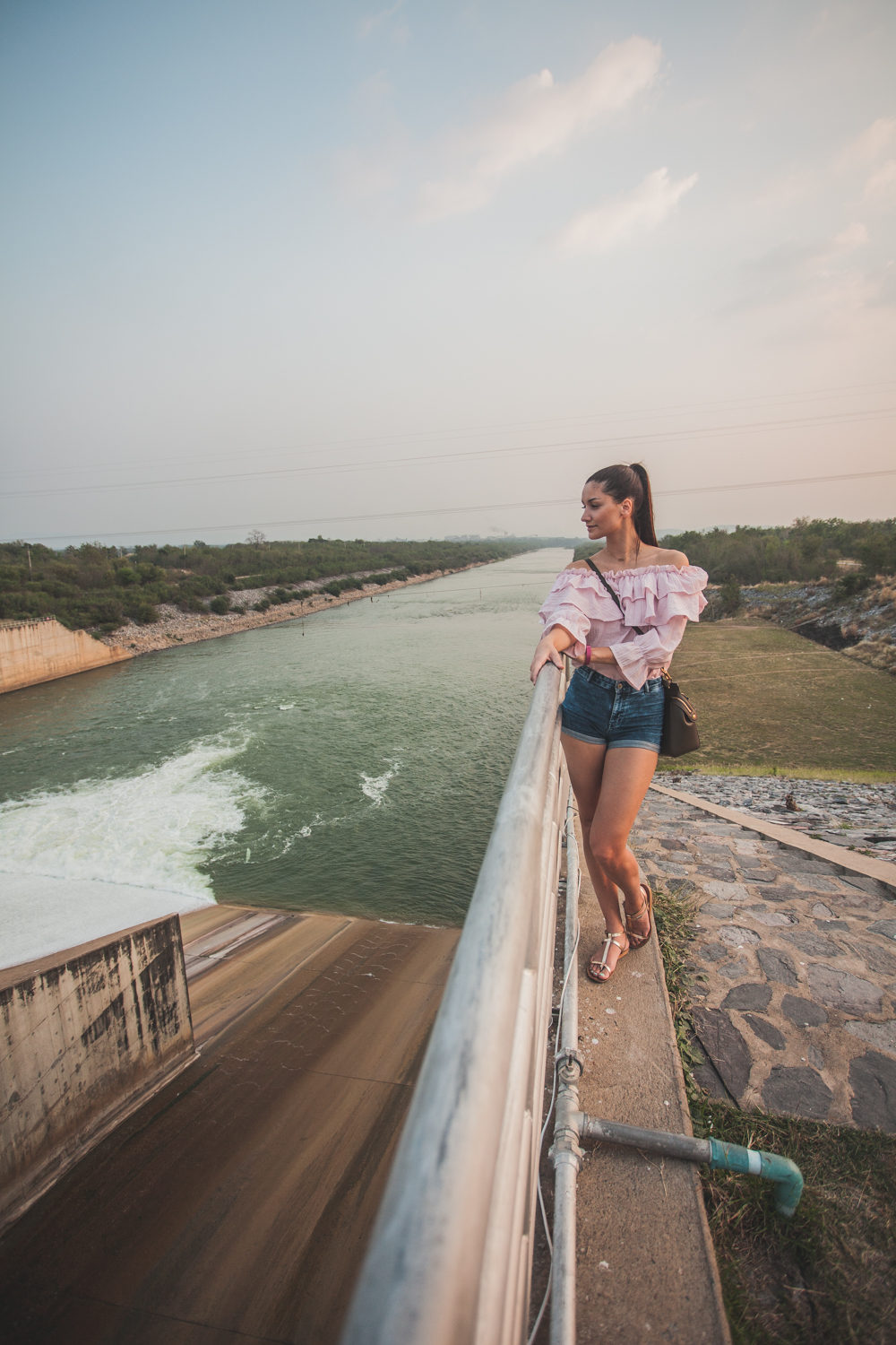 girl looking out to a dam