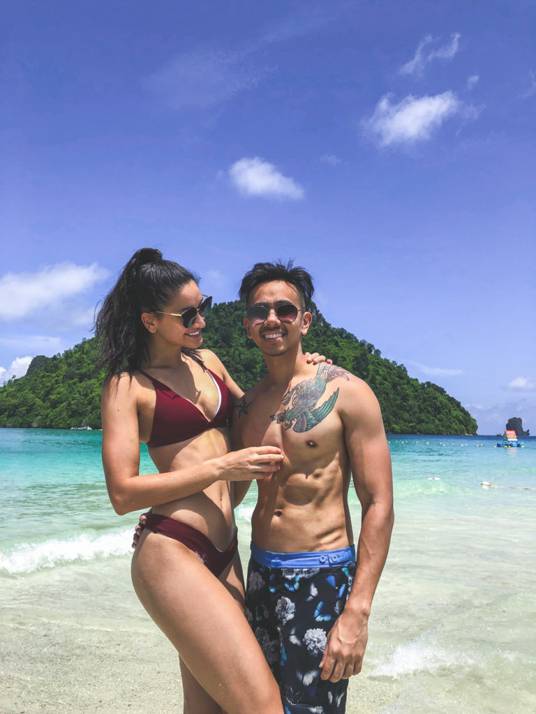 girl looking at her boyfriend on the beach in krabi