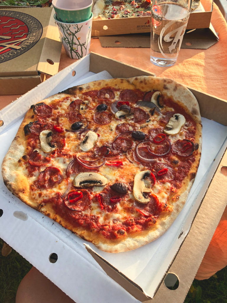 crispy large pizza on cardbard